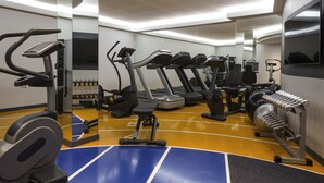 A gym with treadmills, elliptical machines, and weight equipment.