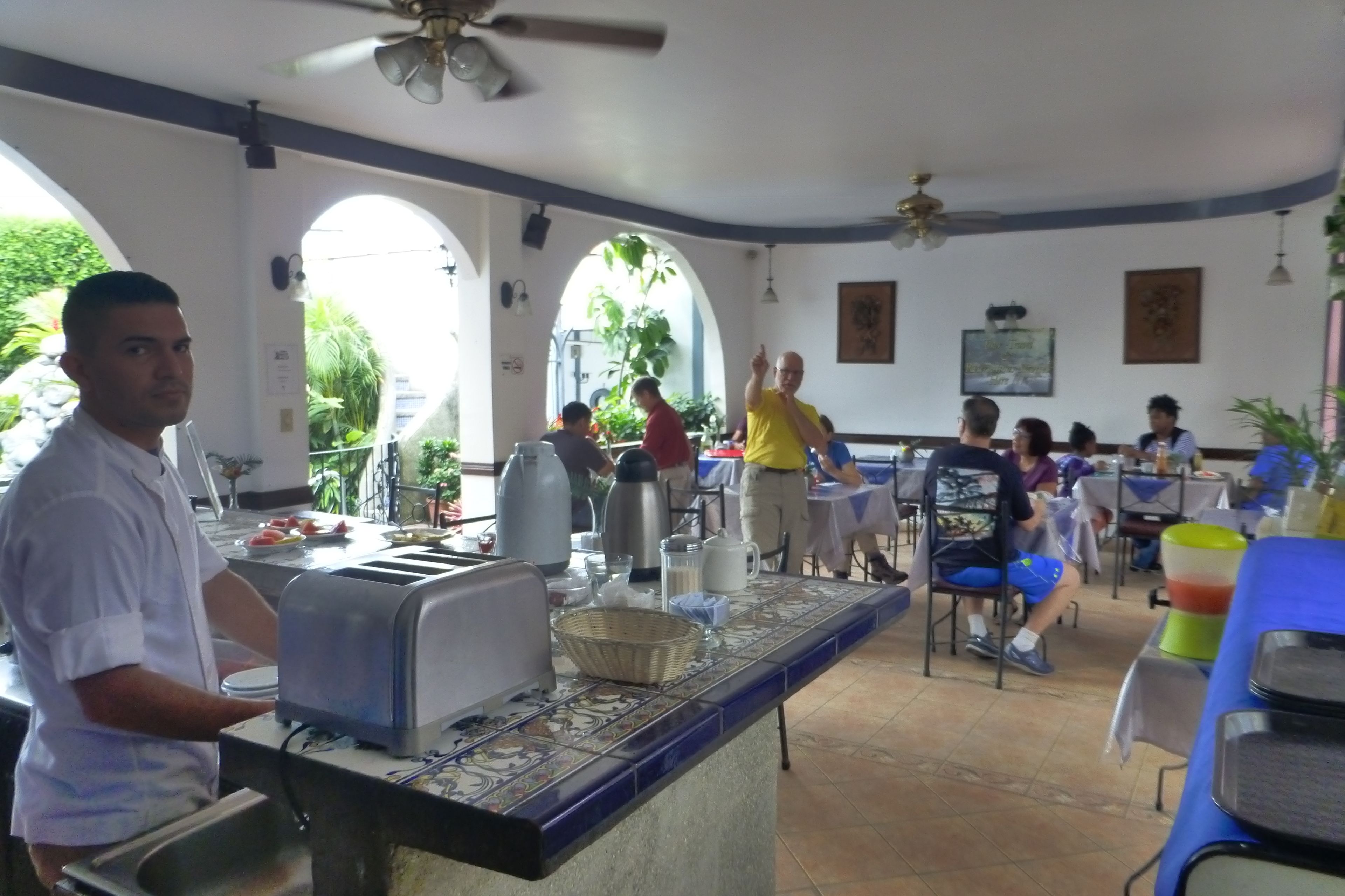 A restaurant with a buffet setup, including a counter with a toaster and a basket.