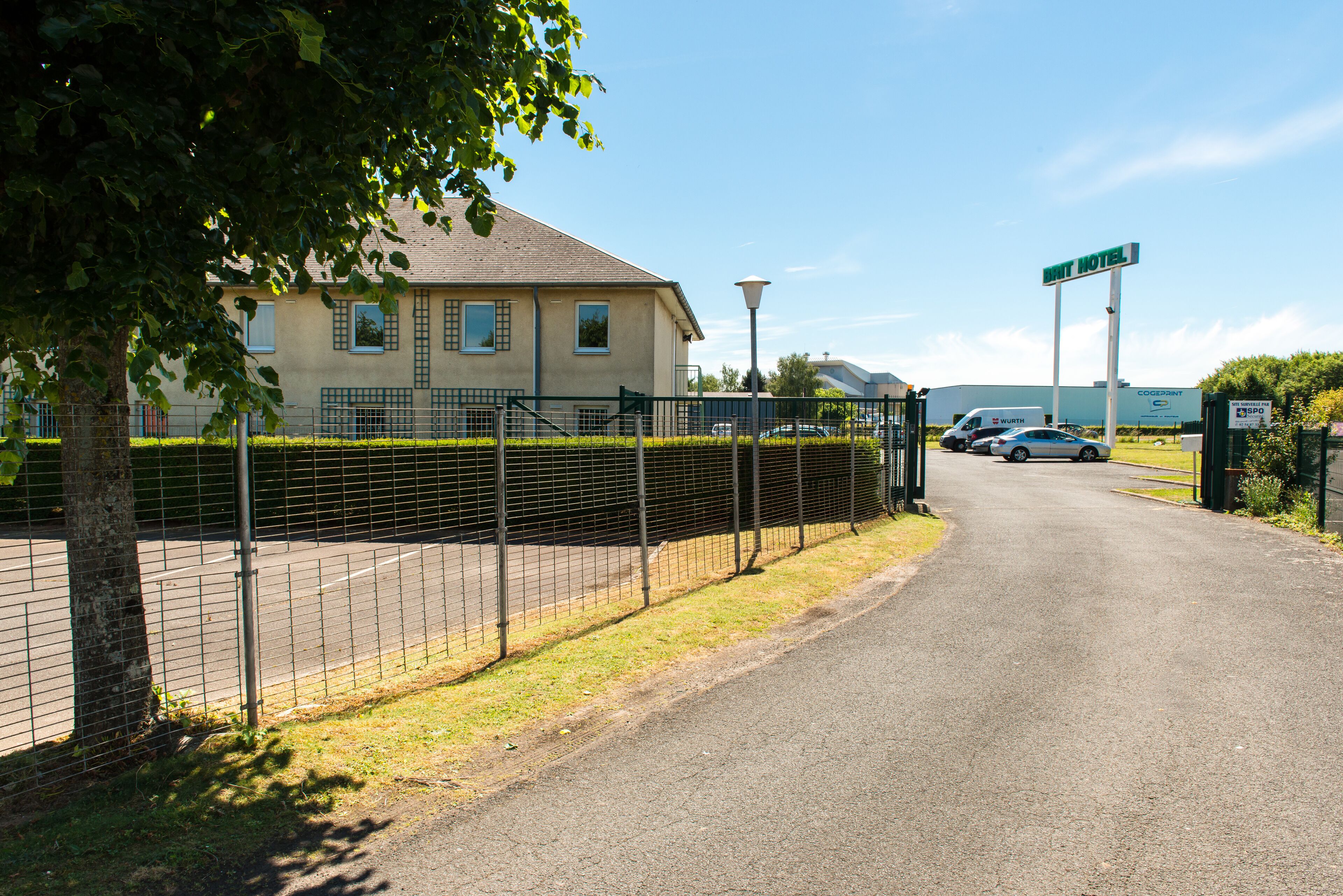 A gated entrance to a building with a sign reading "BRIT HOTEL".