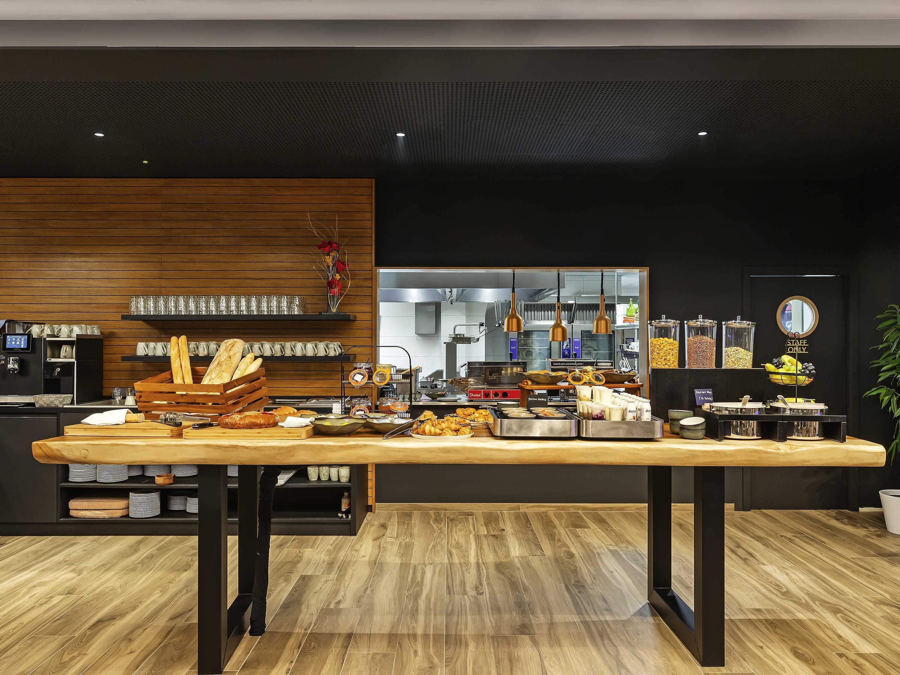 A buffet setup with various food items and a coffee machine.