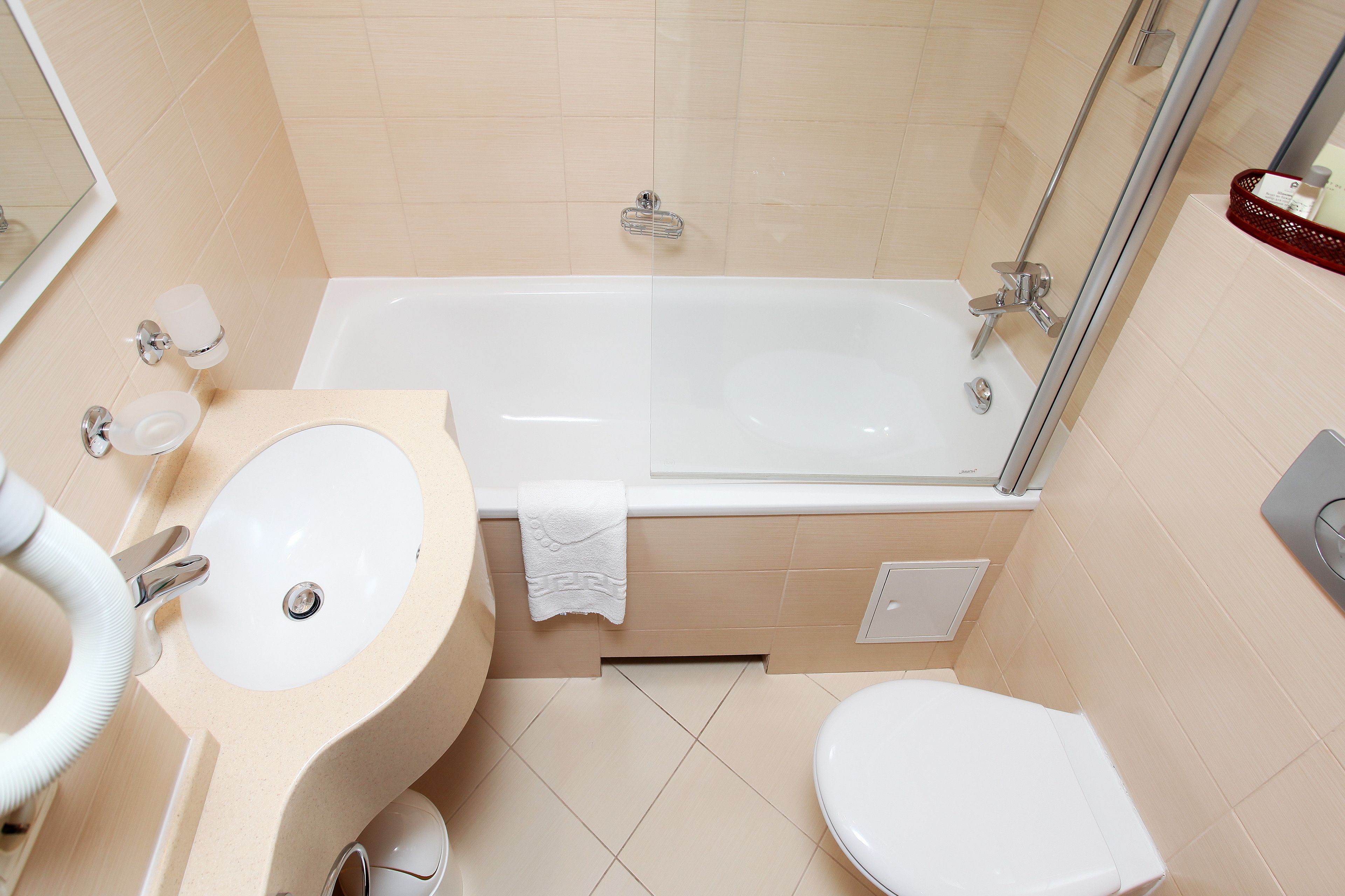 A bathroom with a bathtub, sink, and toilet.