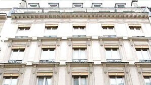 A multi-story building with a classical architectural style, featuring evenly spaced windows and balconies. - Hôtel Elixir (Paris)