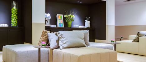 A modern living room with a sectional sofa, a small round table, and a decorative vase.