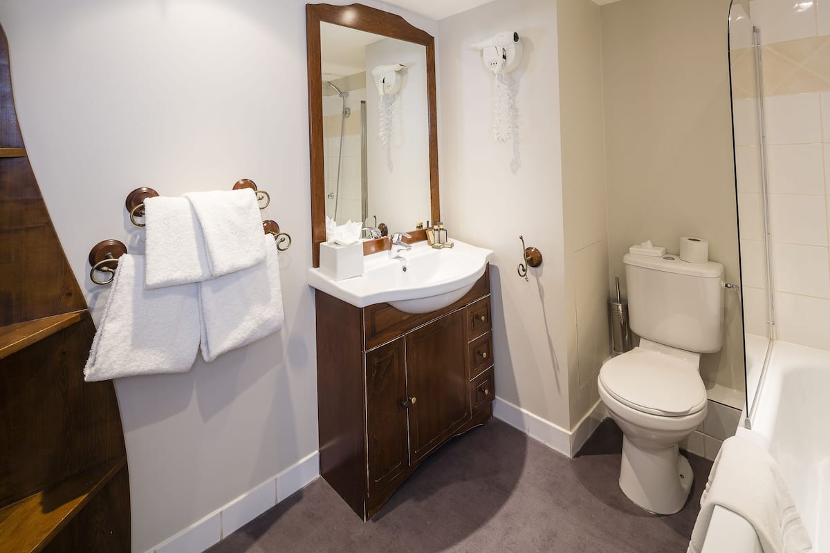 junior suite | bathroom | designer toiletries, hair dryer, slippers, towels