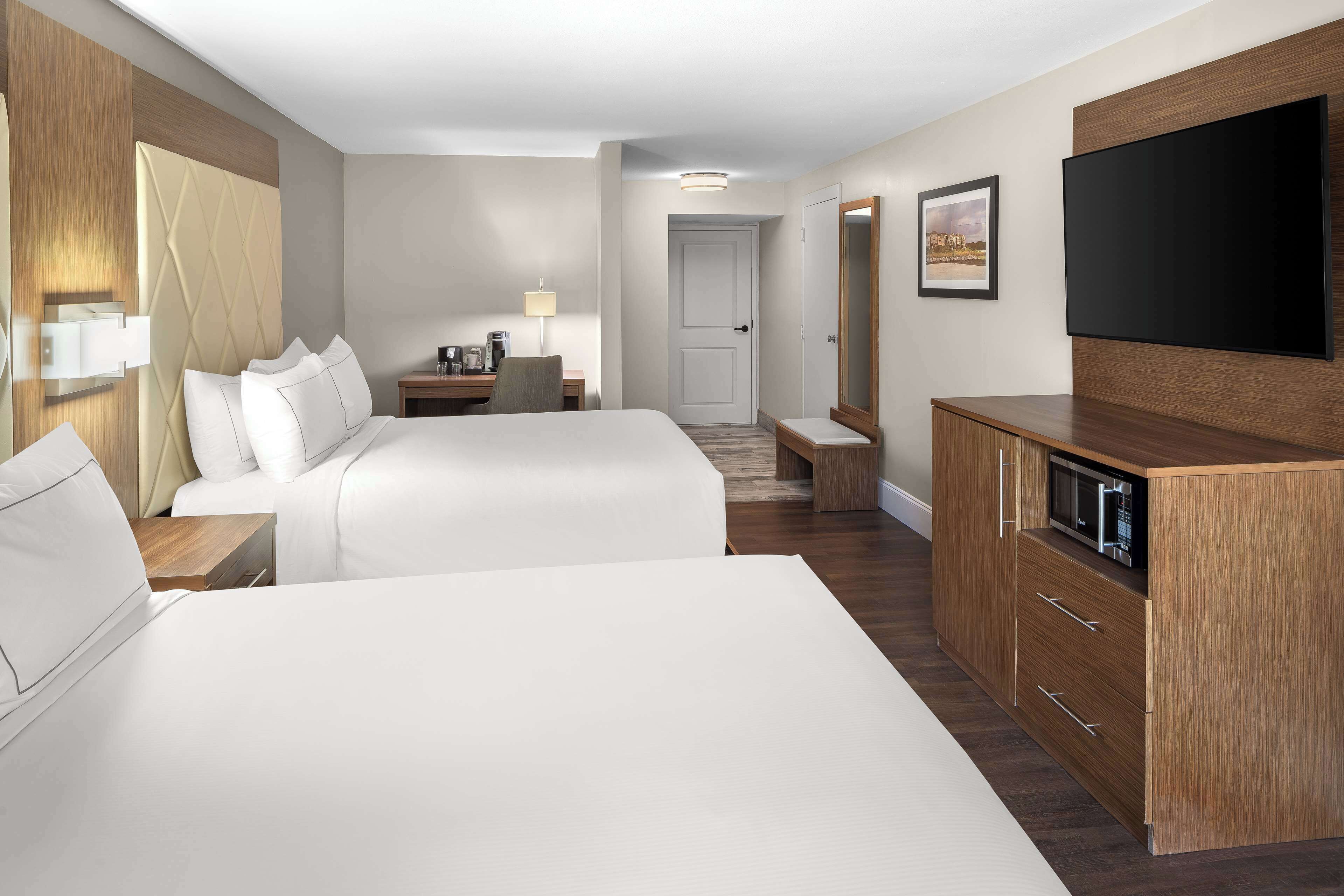 Premium bedding, desk, laptop workspace, blackout drapes