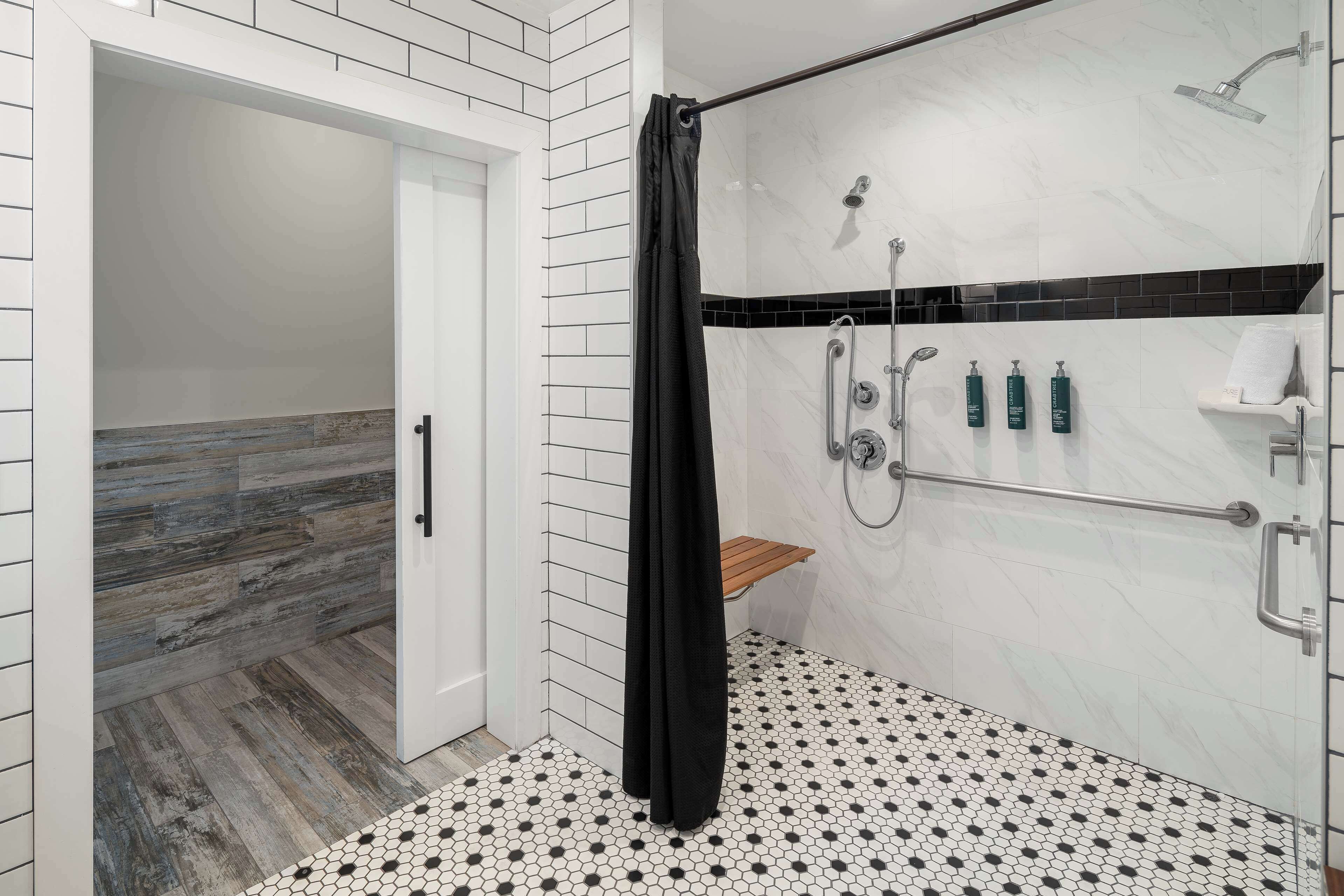 A modern bathroom with a shower, a toilet, and a sink.
