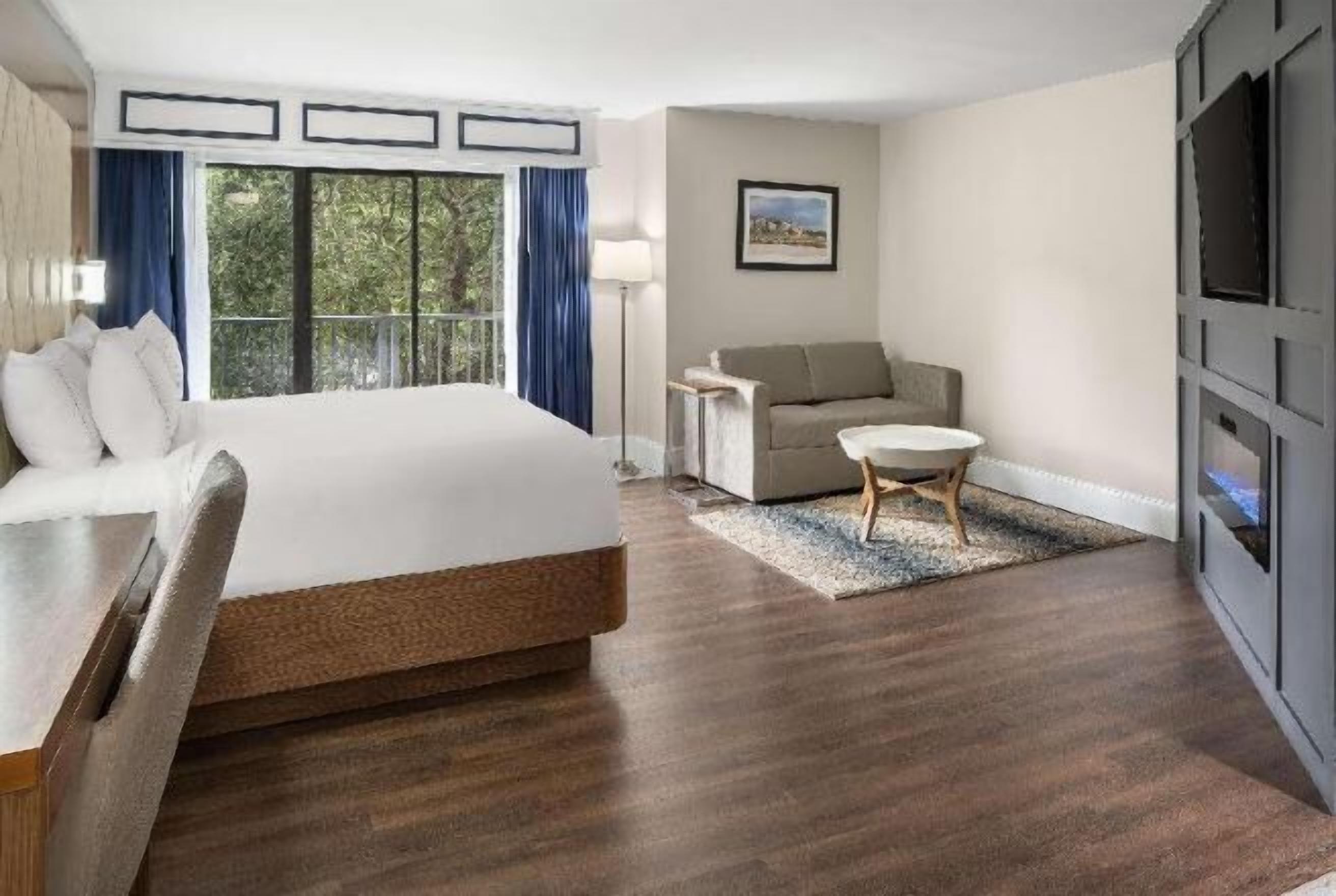 Premium bedding, desk, laptop workspace, blackout drapes