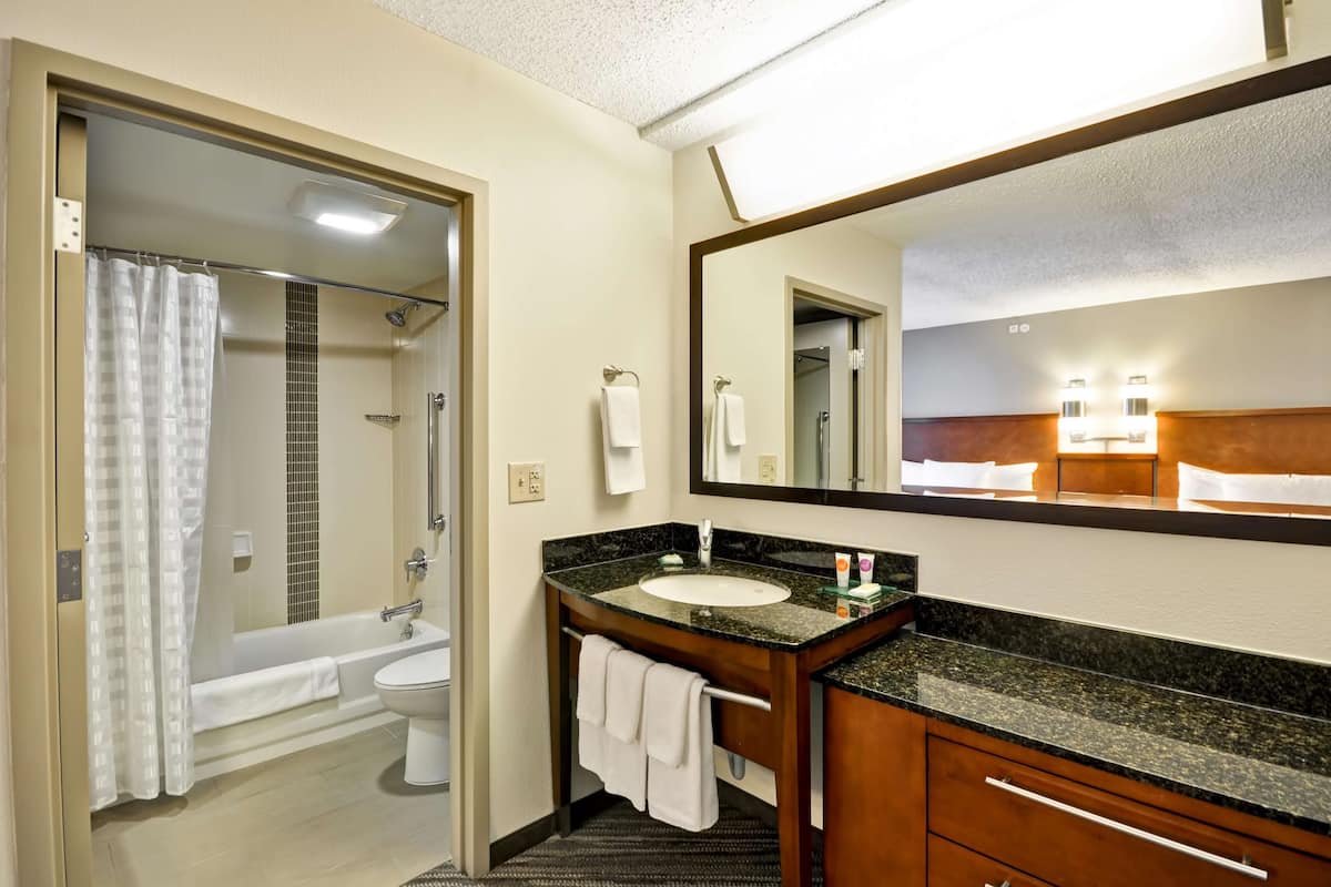 combined shower/bathtub, designer toiletries, hair dryer, slippers