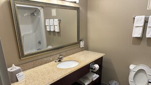 A bathroom with a sink, mirror, and toilet. - Holiday Inn Express Vernon - Manchester by IHG (Vernon)