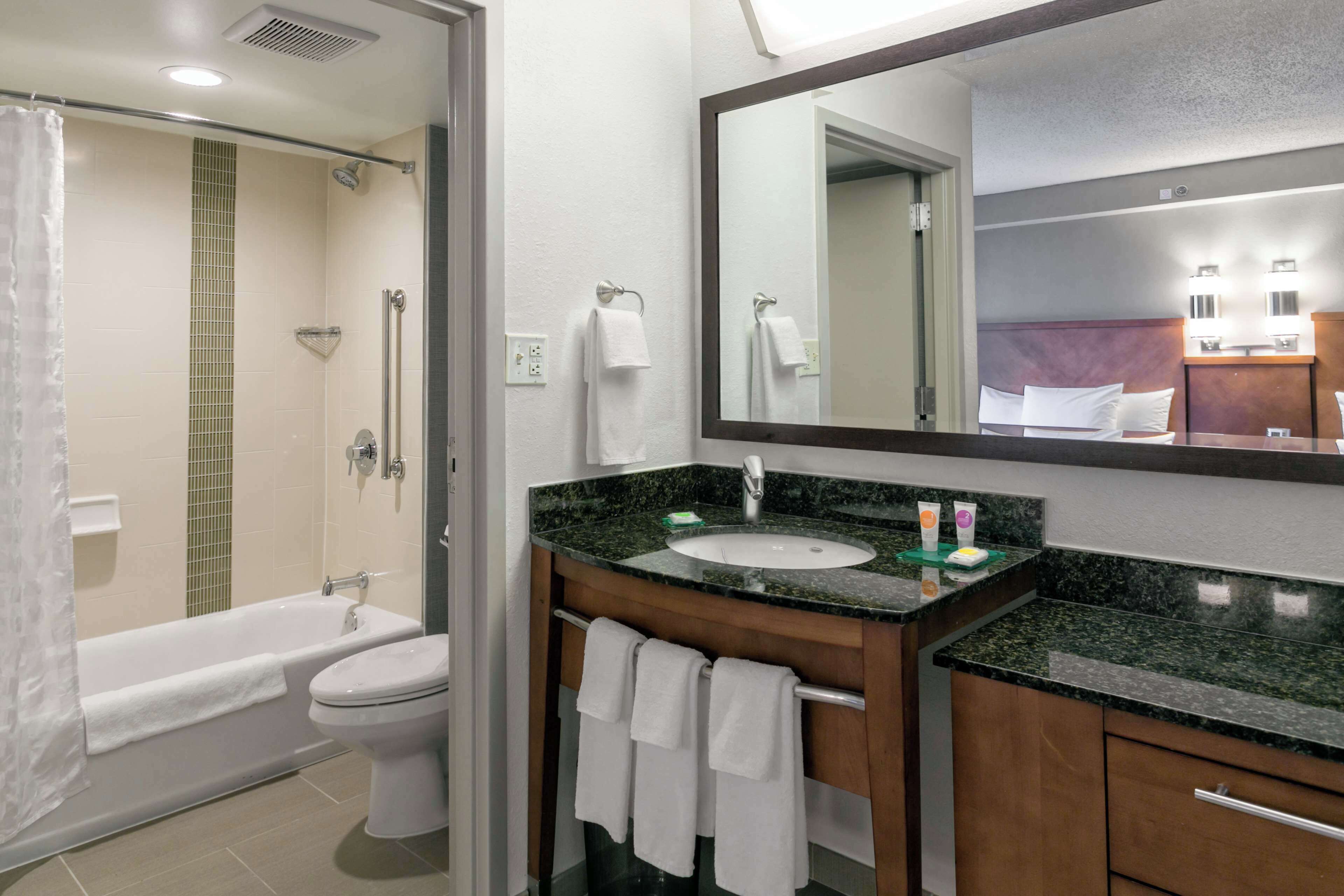 designer toiletries, hair dryer, towels