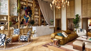 A spacious living room with a sofa, chairs, a coffee table, and a bookshelf filled with decorative items. - Faraway Martha's Vineyard (Edgartown)