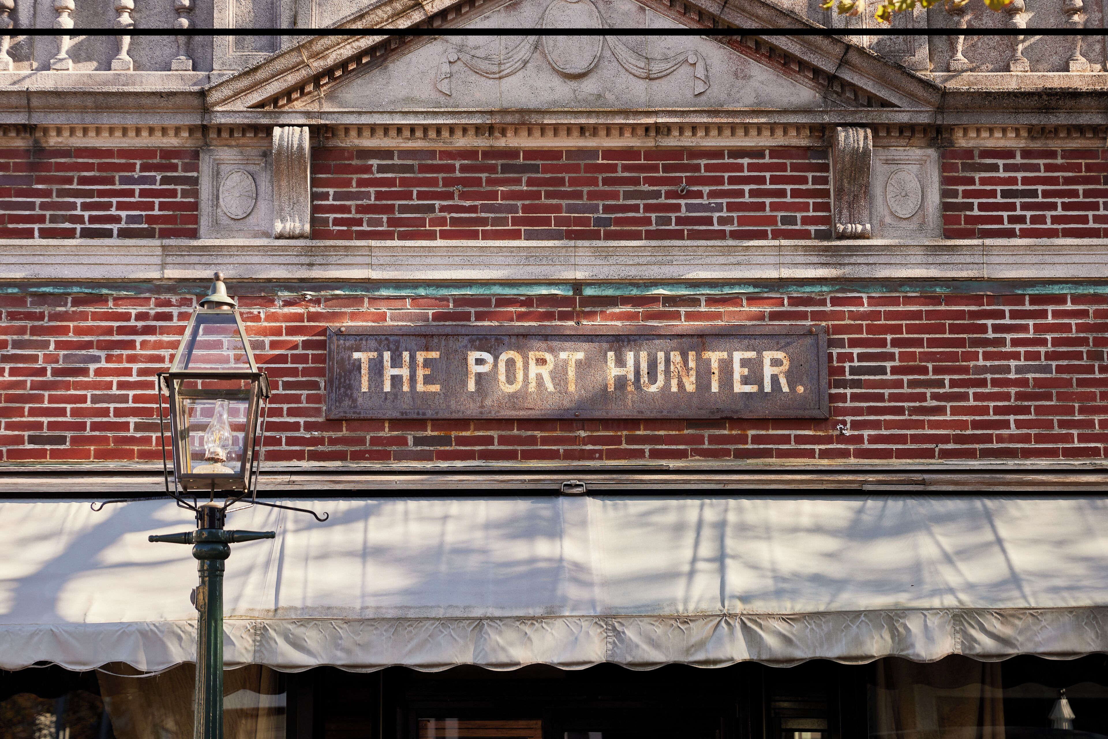 A brick building with a sign reading "The Port Hunter."