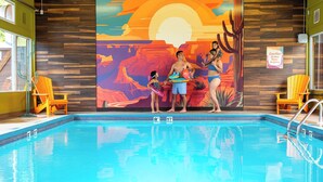 A swimming pool with wooden paneling and a mural of a desert sunset. - Hotel Zed Victoria (Victoria)