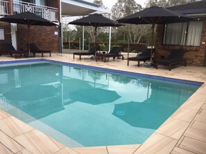Outdoor pool, open 9:00 AM to 7:00 PM, pool umbrellas, pool loungers