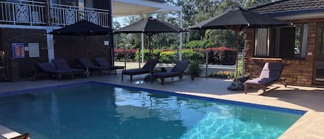 Outdoor pool, open 9:00 AM to 7:00 PM, pool umbrellas, pool loungers