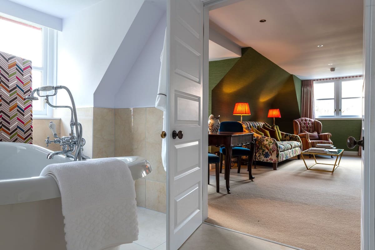 grand suite (master) | bathroom | combined shower/bathtub, designer toiletries, hair dryer, bathrobes