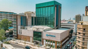 A modern building with a prominent glass facade and a sign reading "Wyndham."