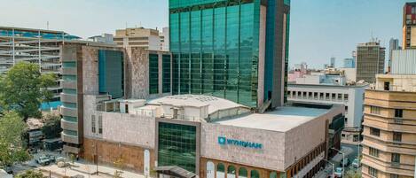 A modern building with a prominent glass facade and a sign reading "Wyndham."