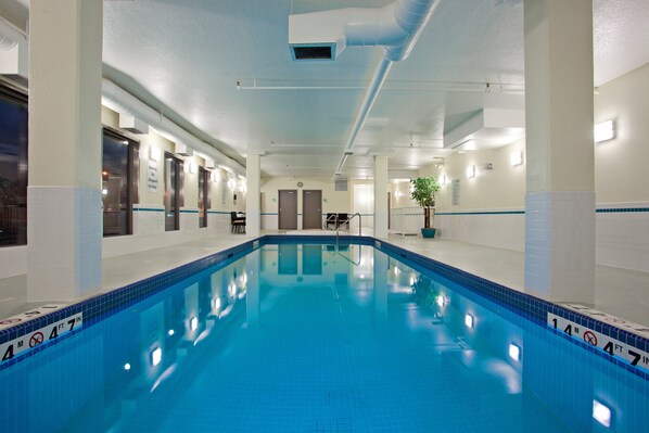 Relax by the rectangular pool with depth markers, surrounded by a clean and modern design.