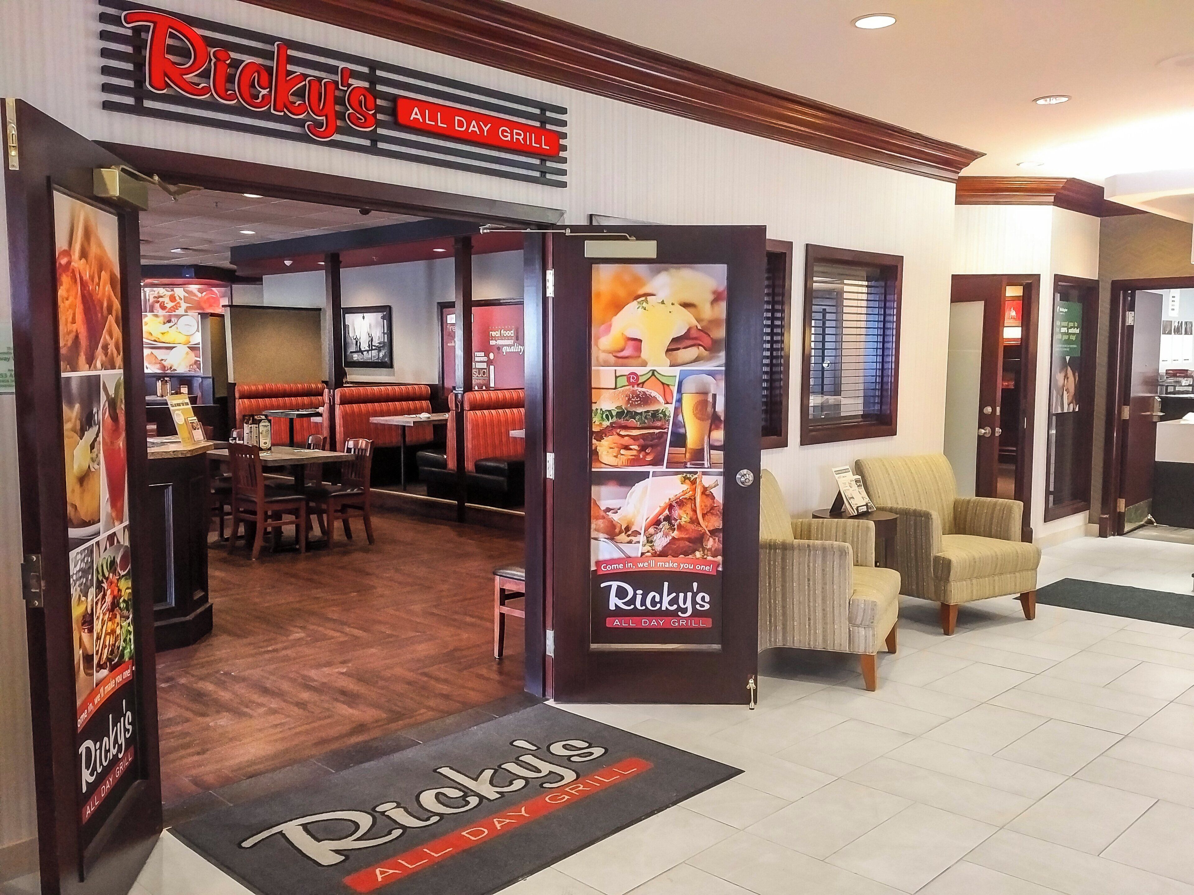 An interior view of Ricky's All Day Grill with booths and a dining area.
