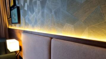 A wall with a textured pattern and a light strip running horizontally.