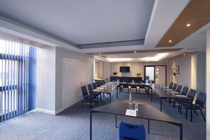 A conference room with a long table, chairs, and a television. - lyf Chelsea London (London)