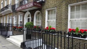 A brick building with a sign reading "Americana Hotel". - Americana Hotel (London)