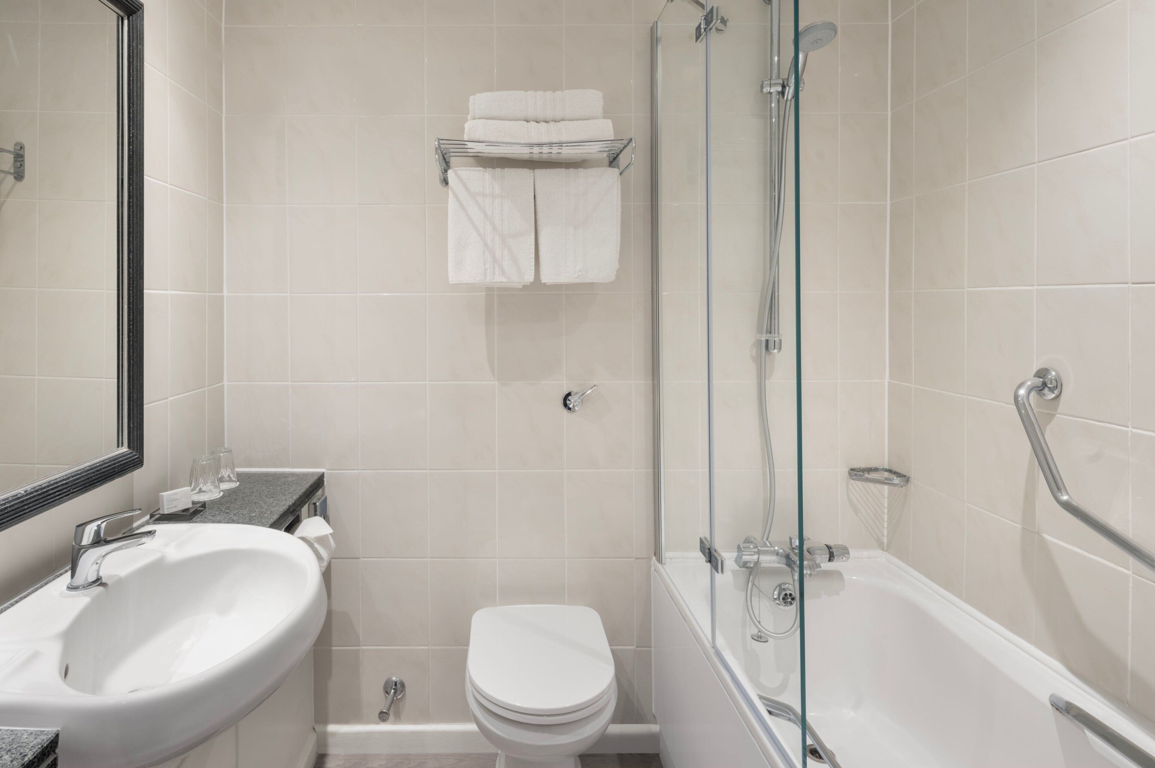 A bathroom with a sink, toilet, and bathtub.