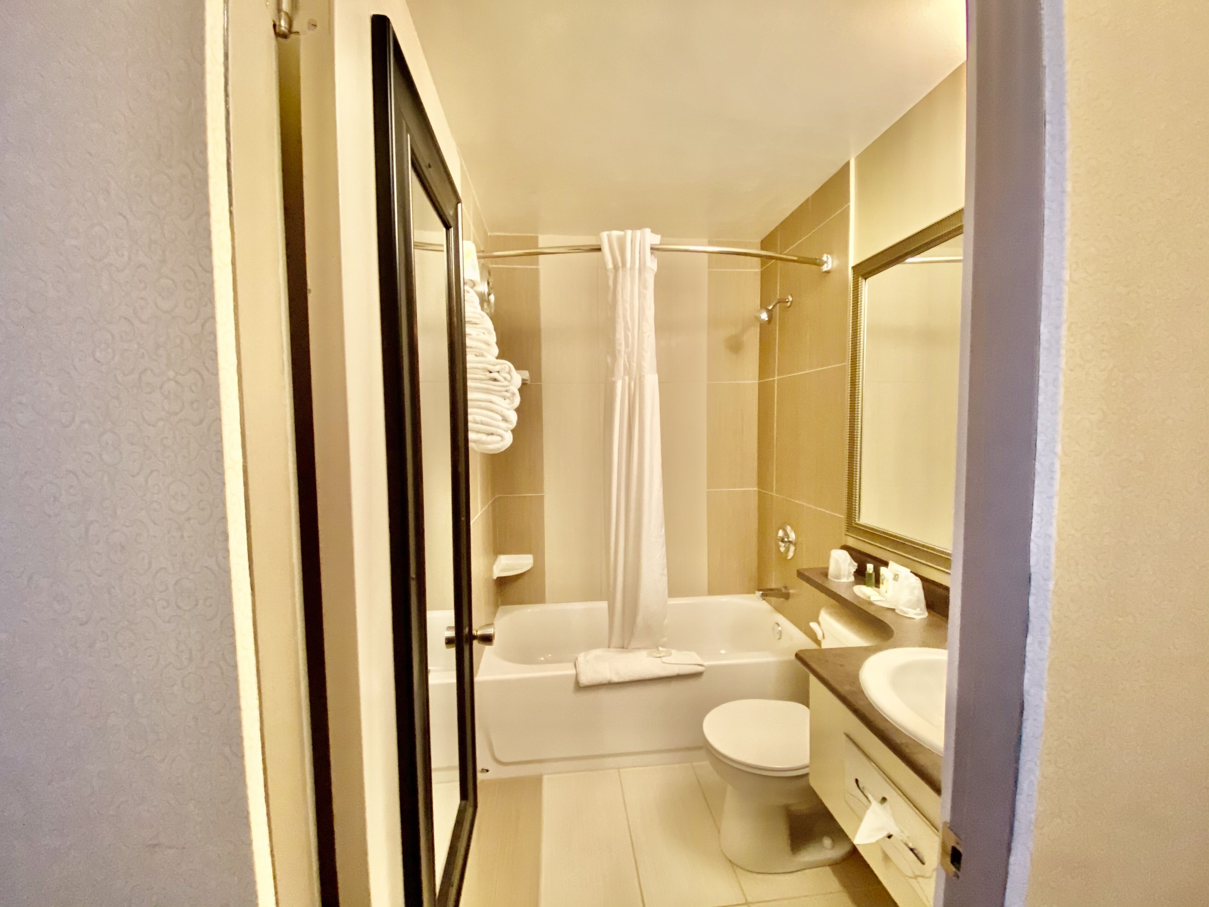 A modern bathroom with a bathtub, toilet, and sink.