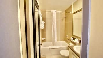 A modern bathroom with a bathtub, toilet, and sink.