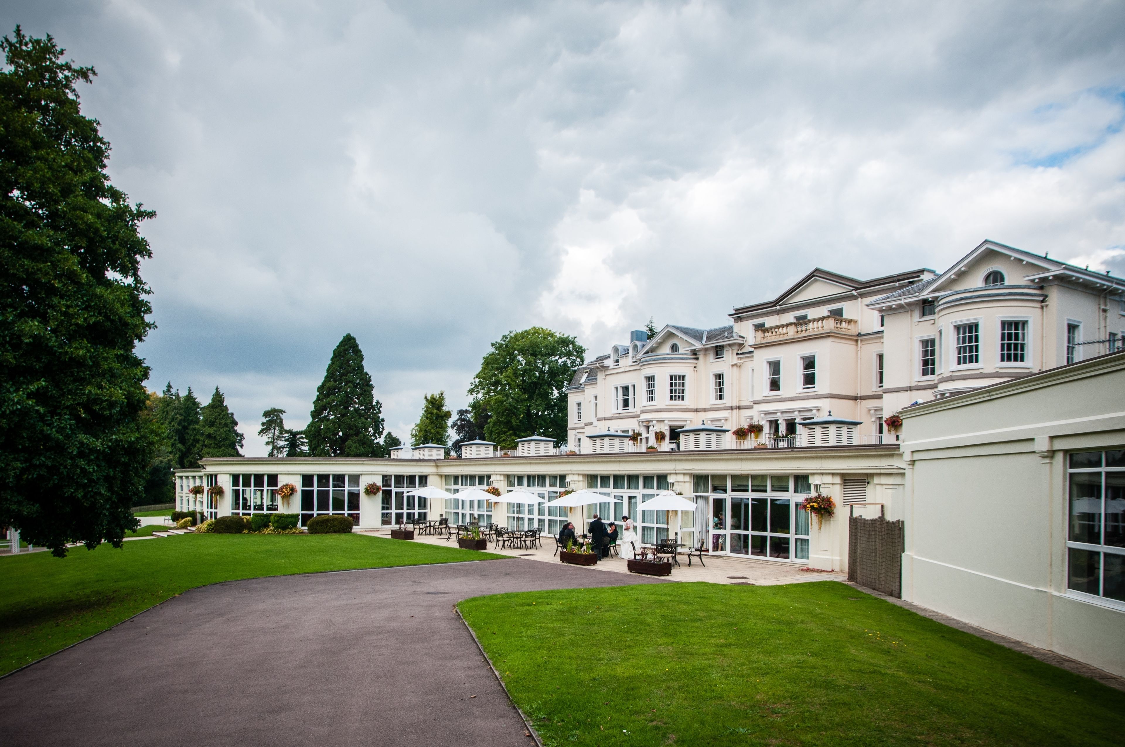 A large, elegant building with multiple windows and a well-maintained lawn.