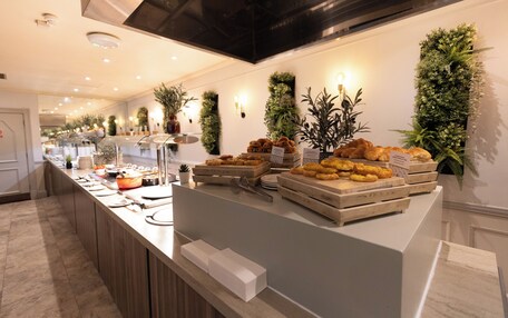 A buffet setup with various food items and a clean, modern interior.