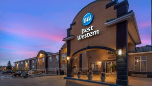 A Best Western hotel with a prominent 'BW' logo, a covered entrance, and a parking area. - Best Western Strathmore Inn (Strathmore)