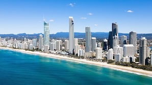 A coastal cityscape with high-rise buildings along a beachfront. - Voco Gold Coast (Surfers Paradise)