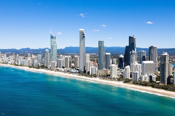 A coastal cityscape with high-rise buildings along a beachfront. - Voco Gold Coast (Surfers Paradise)