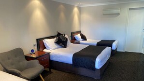 A hotel room with two beds, a desk, a chair, and a clock. - Best Western Plus All Settlers Motor Inn (South Tamworth)