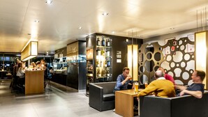 Un área de bar moderna con asientos y una barra.