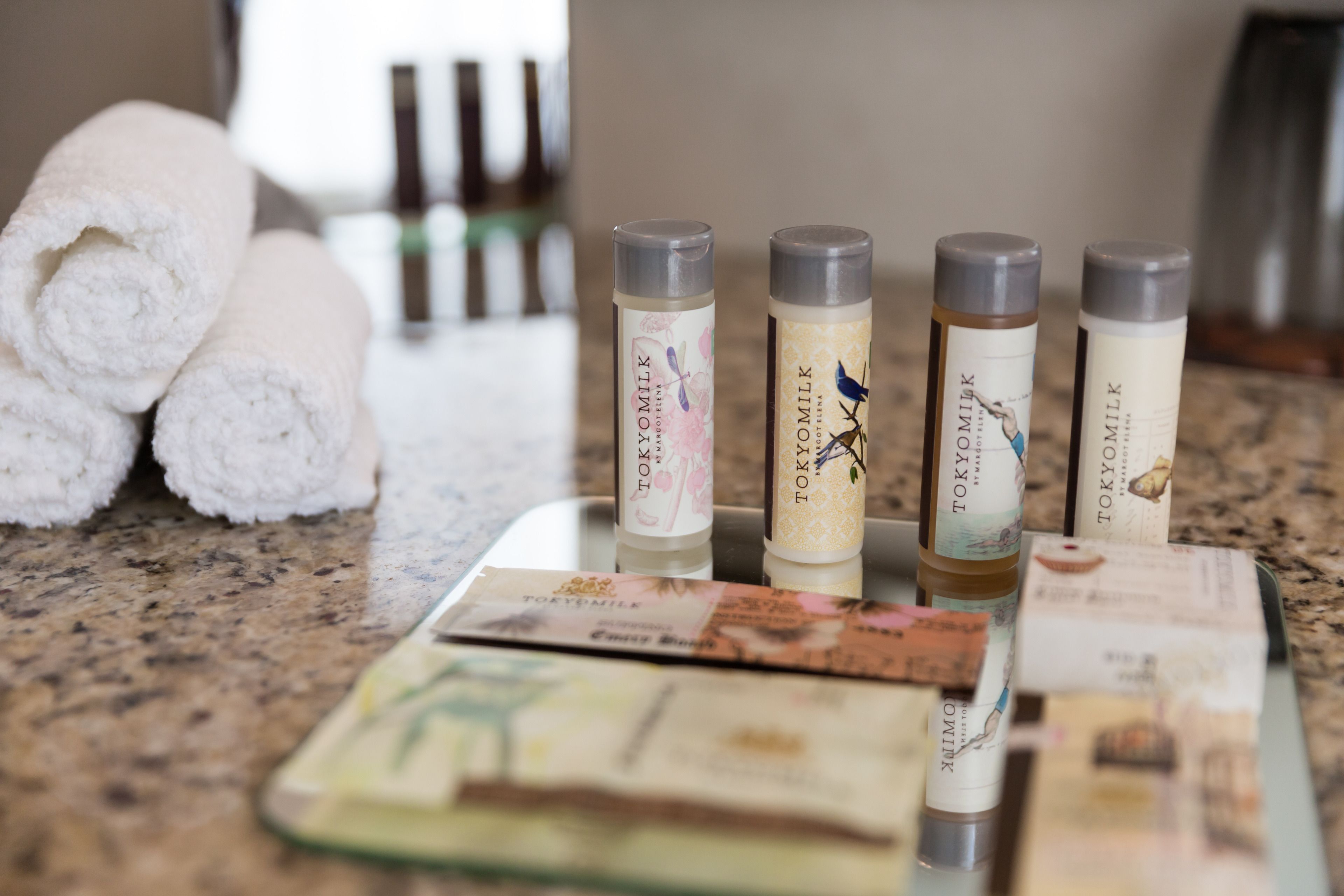 A bathroom counter with toiletries and towels.
