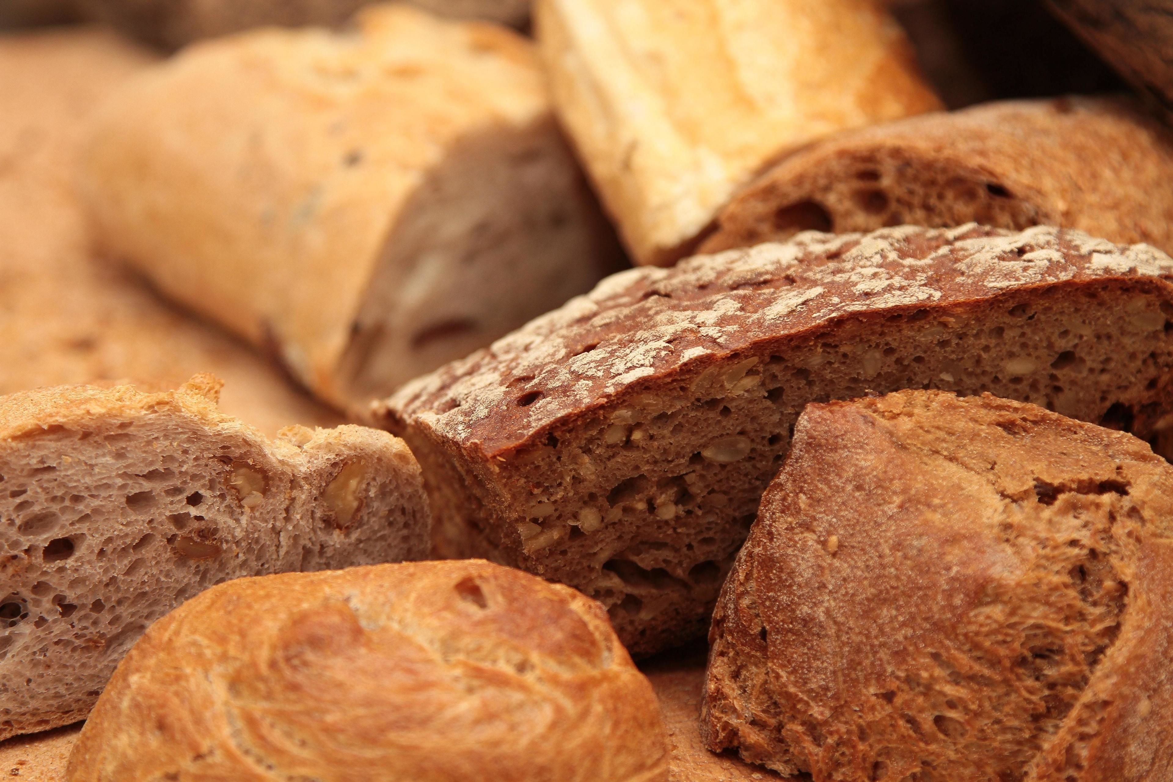 Slices of bread with a crusty exterior and a dense interior.