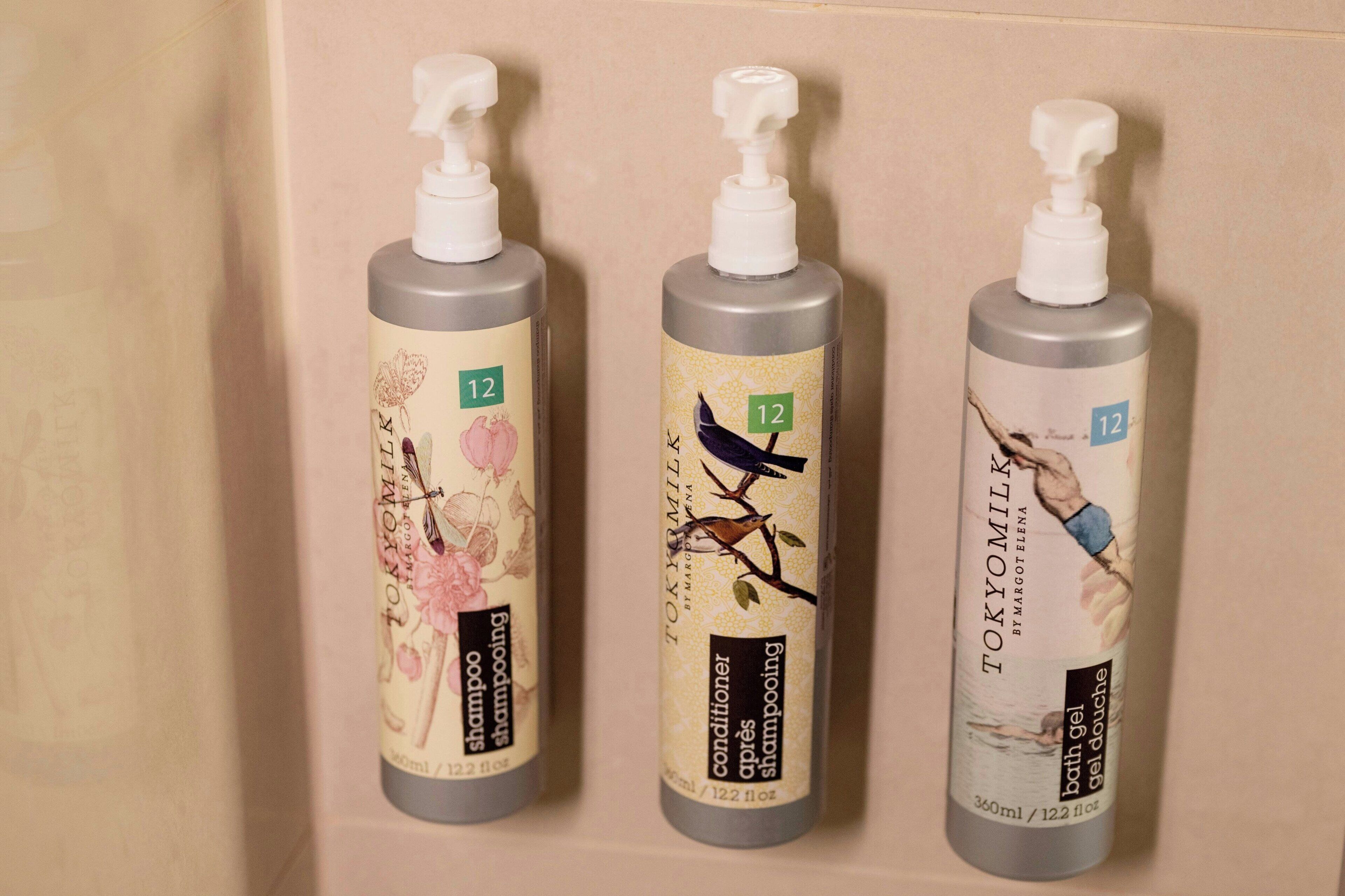 Three toiletry bottles with pump dispensers, each labeled with the number 12.