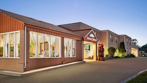 A hotel with a brown exterior, large windows with curtains, and a sign reading "Howard Johnson." - Howard Johnson by Wyndham Gravenhurst (Gravenhurst)