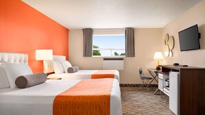 A hotel room with two beds, a desk, a chair, a TV, and a window with curtains. - Howard Johnson by Wyndham Gravenhurst (Gravenhurst)