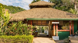 A reception area with a thatched roof and a sign indicating 'RECEPTION'.