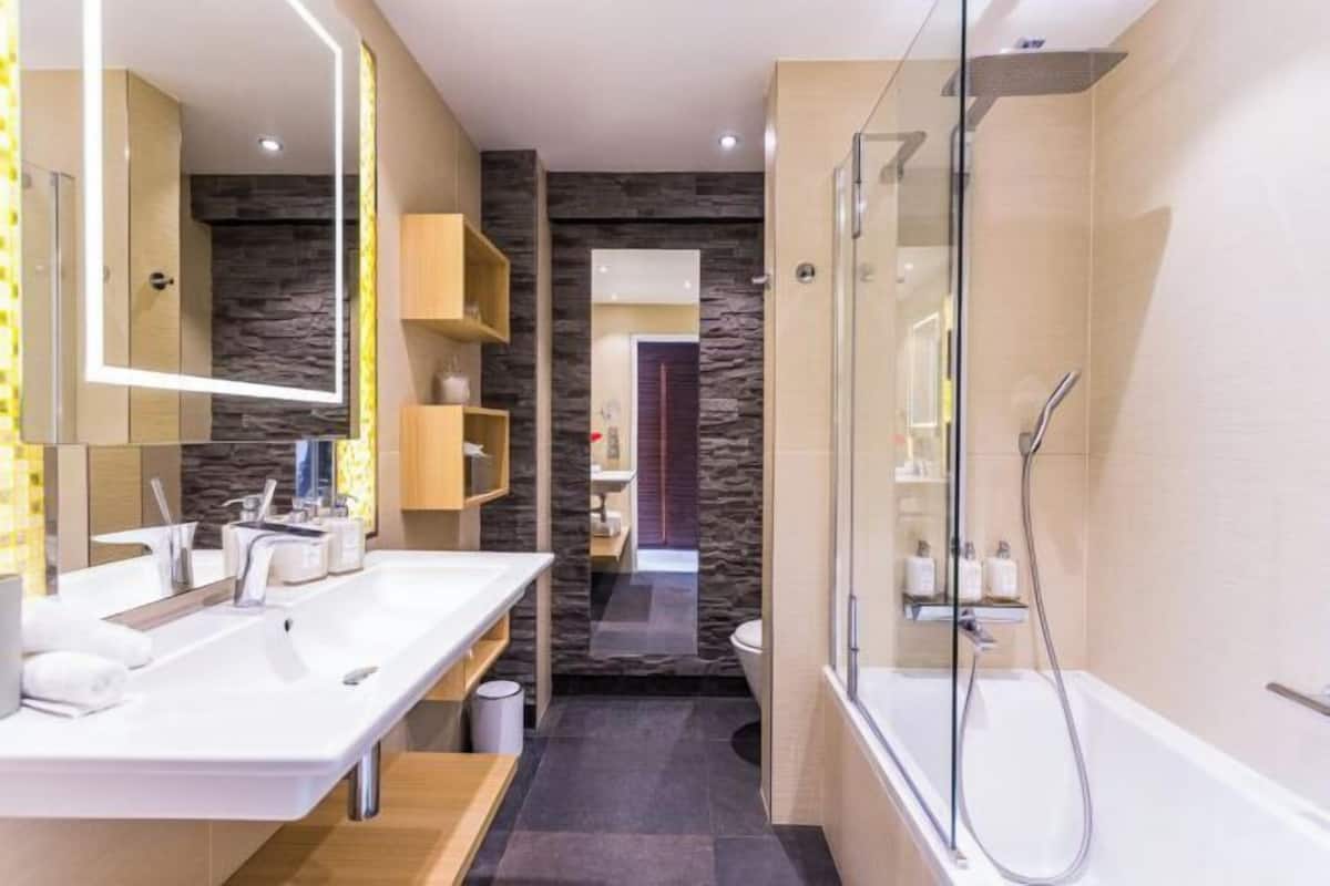 Baño | Tina con regadera, secadora de cabello, pantuflas, toallas