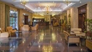 A spacious lobby with leather seating, chandeliers, and a reception desk. - Royal Court Hotel (Coventry)