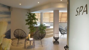 A spa area with modern chairs, a plant, and a wall with 'SPA' signage. - Best Western Les Bains Hôtel & SPA Perros-Guirec (Perros-Guirec)