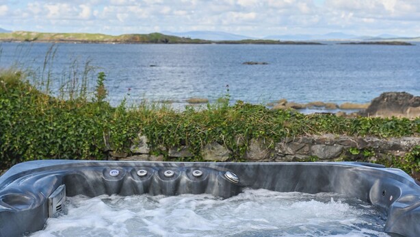 A hot tub with a view of a lake and hills. - Renvyle House Hotel & Resort (Renvyle)