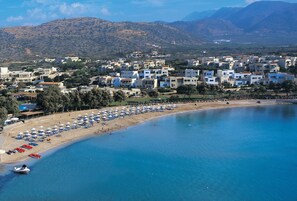 On the beach, sun-loungers, beach umbrellas, waterskiing