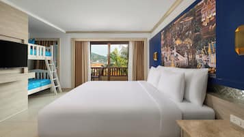 A hotel room with a large bed, a TV, a balcony with a view, and a mural on the wall.