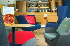 A modern restaurant interior with seating and a bar area. - Holiday Inn Express Burton Upon Trent by IHG (Burton on Trent)